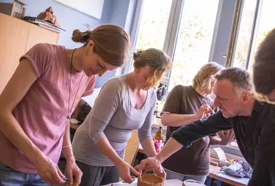 Teilnehmende modellieren jeweils eine Schüssel aus Ton. 